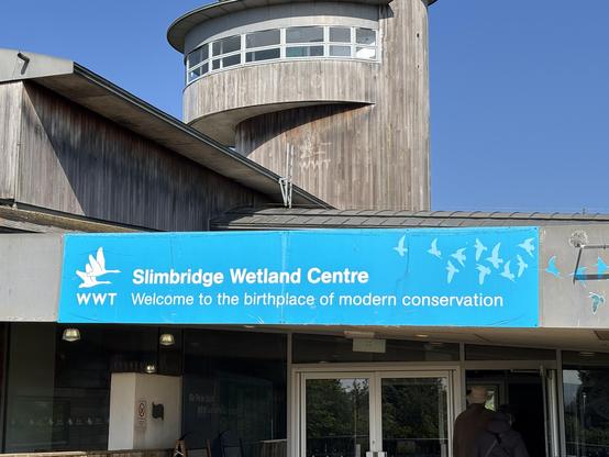 Slimbridge wetland centre - with a sign above the door, which says “ Slimbridge wetland centre”