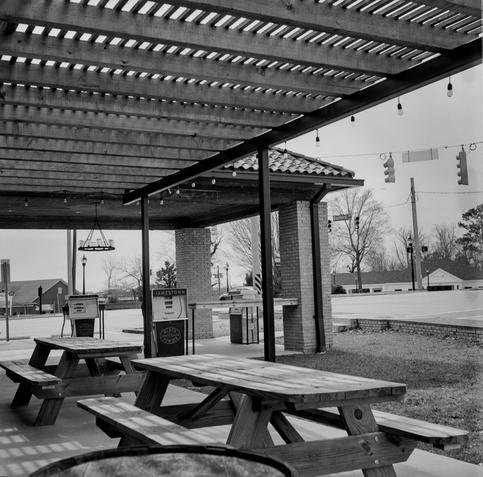 An outdoor view of the Black Powder Smokehouse in the small historic town of Jamestown, North Carolina.  There is a filling station motif both inside and outside including some old school fuel pumps as shown.