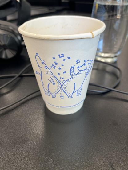 A pair of bears (ursine not homo subspecies) making ass music(?) and droppings into what I assume is meant to represent this single use cup(??)