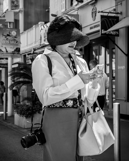Lady in the street watching her smartphone
