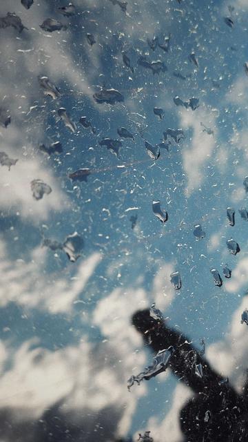 Reflection of sunset sky on the window of a car. Raindrops. Dust.