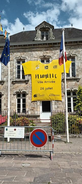 Giant yellow jersey, worn by the tour leader, hanging from a building in the centre of town.