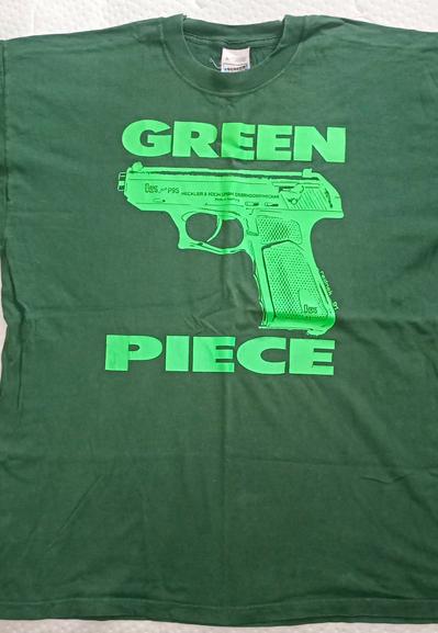 Bottle green t-shirt with a neon green image and text.

Between the words GREEN and PIECE is a Heckler Koch PS9 automatic pistol.