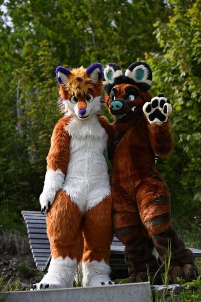 Fullsuiters Fox Flummox and AWD Captain Flips waving into the camera