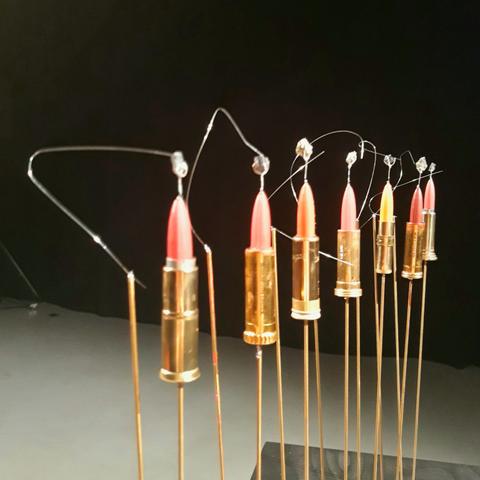 A series of lipsticks mounted on copper rods, each with a crystal mounted on top and a fine metal wire making a point contact with the crystal.