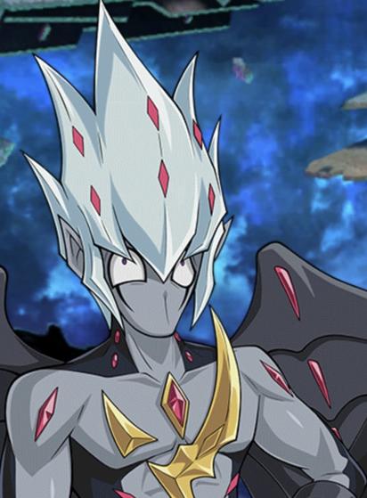 Screenshot of a dude with grey and black skin or skintight suit who has a golden emblem on his chest and red gems on it, very spiky white hair and makes a goofy face that is only expressed with very wide eyes because he doesn’t have a visible nose or mouth.