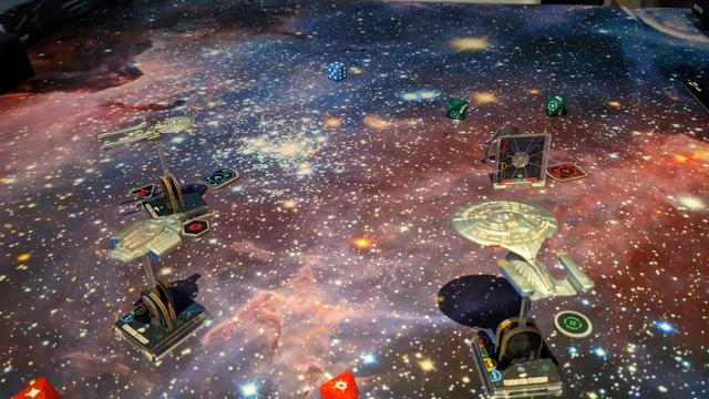 A blue, purple and white space mat with spaceships on it.