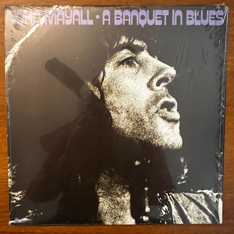 A Banquet In Blues front cover – with a dark, mezzotinted photograph of John Mayall's face in profile.