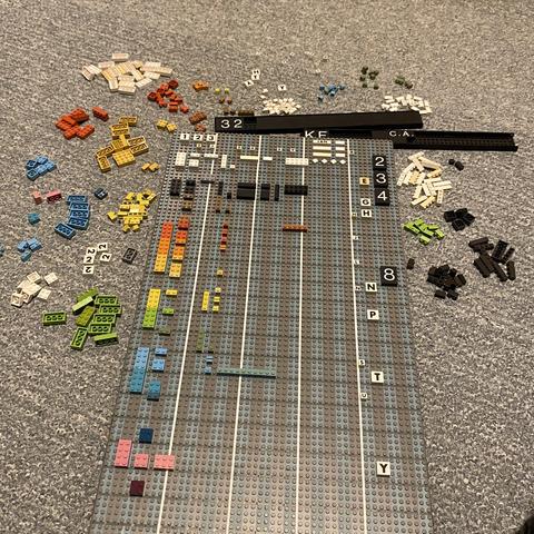Baseplate with lots of colorful and printed bricks. Joy