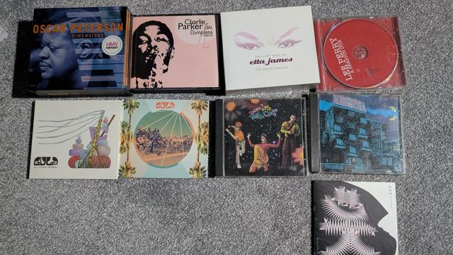A photo of CDs on a floor with these being by the following :
Oscar Peterson, Charlie Parker, Etta James, Lee Perry
Gulp, Gulp, Dee Lite, Borghesia,
Das Koolies
