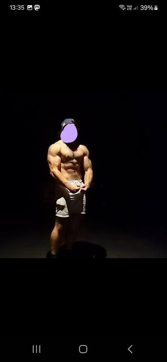 The profile picture of the guy who made the comment. He's not wearing a shirt and has his arms flexed in front of him, the room is dark and he's lit from above to really show off his chest muscles.
This picture looks like a very typical gym bunny Grindr pic.