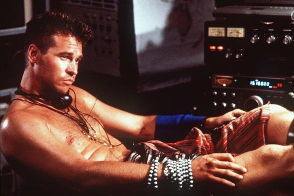 Val Kilmer with a blue arm brace slid down his forearm