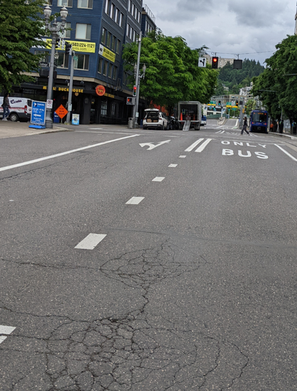 Truck unloading in the bike lane ahead, I'm riding in the bus lane