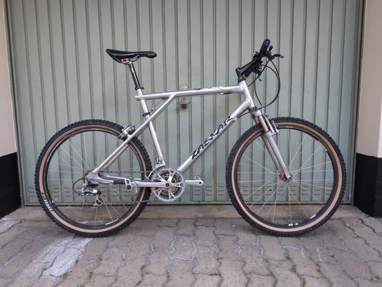 Photo of a vintage mountain bike with a silver frame.