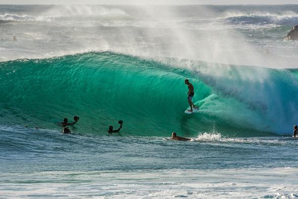 Surfers on a wave.