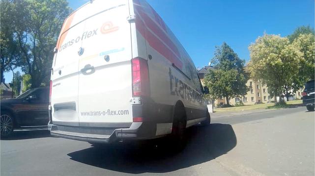 Image of a dashcam on a bicycle just before a junction. The van now turns right - the distance between the bike and the van here is less than one meter