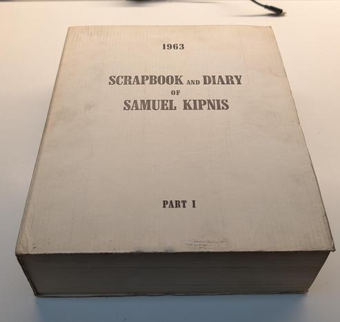 photo of a thick, bound hardcover book titled 
1963
SCRAPBOOK AND DIARY OF SAMUEL KIPNIS, PART 1.