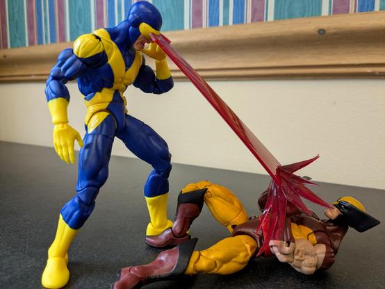 The Marvel Legends X-Men 97 Cyclops blasting a grounded kitbash Wolverine with his laser vision