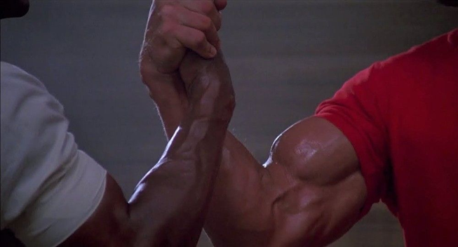 The internet meme of a beefy white man's arm handshaking/arm wrestling with a similarly beefy black man's arm, which is from Predator when Arnold greets Carl Weathers