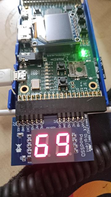 Circuit board with 7 segment circuit board attached. The two 7 segment displays show the number 69 (nice).