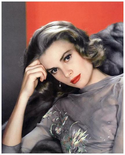 Grace Kelly wearing a gray dress. She has brown hair with highlights
