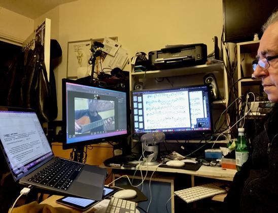 Me in the middle of the chaos that is my teaching environment, during an online guitar lesson.