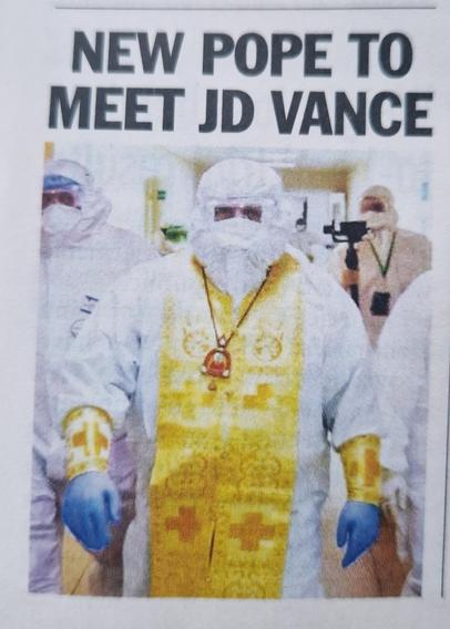 Picture is a close up p of three people in full bio hazard suits.
The one in the centre adorned wit religious paraphernalia