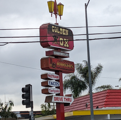 Vertical sign for the Golden Ox: Pastrami, tacos, teriyaki