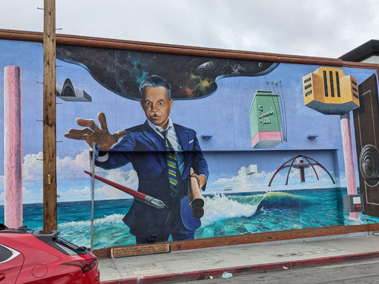 Mural of a man levitating LA landmarks or of rising waters