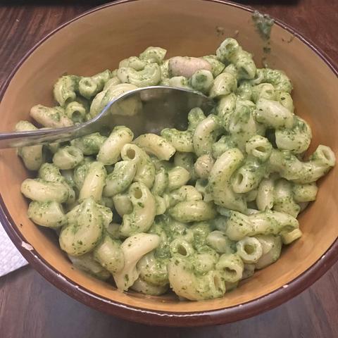 Yellow bowl with elbow noodles and green sauce