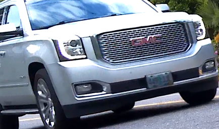 grey GMC Denali SUV with smoked plate cover on the front