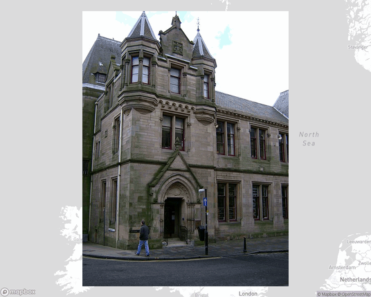 A photo of or from a library from the linked website, overlaid on a cropped world map where it's located.
