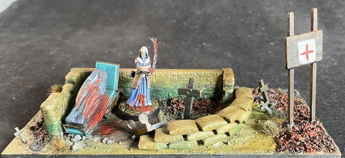 Combat medic stood in a hospital ruin next to a bier