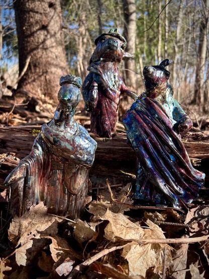 A group of three magical creatures out in the forest.  A bear, goose and cow without eyes.
