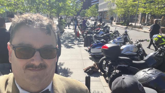 Selfie in front of a row of motorcycles.