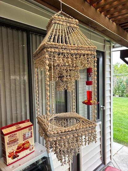 Hanging macrame sorta thing, but covered in shells