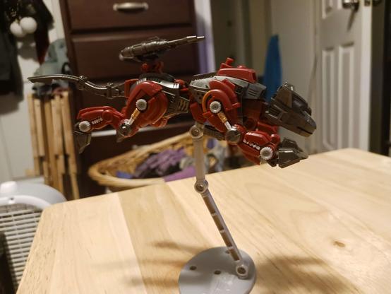 Another photograph of the completed Zoid. In this one it's posed in a pouncing stance, held up on the small grey flying base it comes with.

It's... not nearly as good as the Bandai bases, not gonna lie.