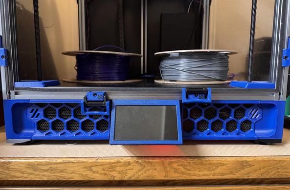 A photo of the front of my trident showing that the blue hexagon skirts at the bottom of the letter now have black mesh inserts that still allow airflow but visually obscure more of the electronics.