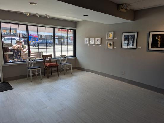 Inside a gallery looking out the window. A few small 2D works on the right side
