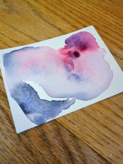 This watercolor swatch is made using Schmincke Wild Purple and Shadow Grey. The wild purple masstone is more red than purple and the water pushes it to granulate into bursts of vibrant bright pink and grittier blue. With more water, the colors are just a lighter value. The shadow grey is a smokey blue and granulates similar to the blue in the wild purple; however it leaves a black edge.
