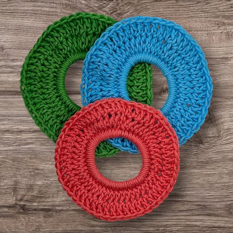 A style of regular sized scrunchie in coral, green, and blue.