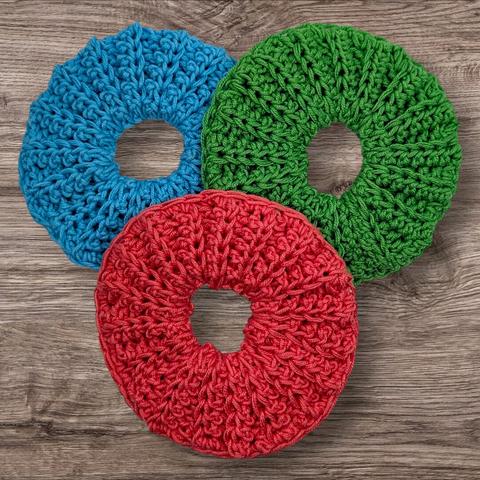 A style of chunky scrunchie in coral, green, and blue.