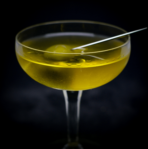 The cocktail itself in a chilled coupe and garnish with an olive
