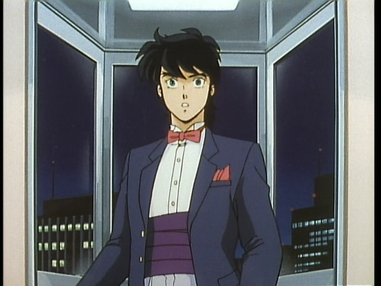 Ryo has a suprised look on his face. He's wearing a tux with red bowtie, red hankercheif, and coverbun.