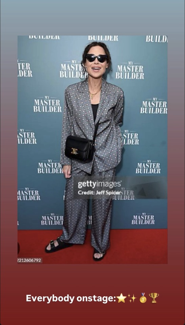 Instagram Story with another Getty Images photo of Minnie at the opening night party. She stands on a red carpet in front of a blue wall with the play's title written on it in a repeating pattern. She leans slightly forward towards the camera and her mouth is open in a smile. Her eyes are hidden behind a pair of dark sunglasses. Below the photo, Minnie writes: “Everybody onstage:” followed by 4 emojis: Star, Sparkles, Medal, Trophy.
