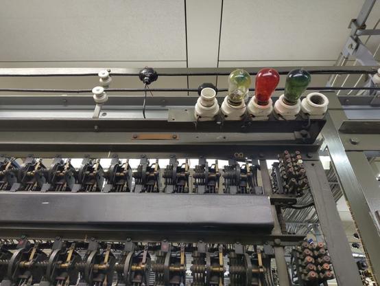 Analogue telephone switching matrix, a yellow, red and blue light bulb.