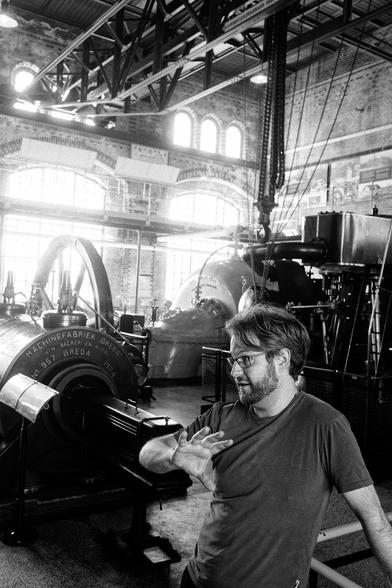 Nathan gesturing in front of a steam engine