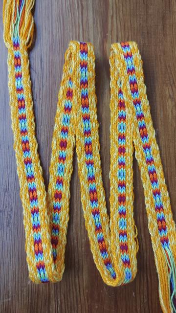 Finished colourful band from the first photo showing its front and back.