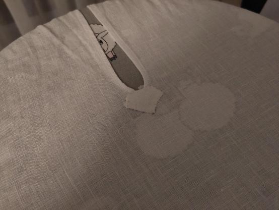 A (neck) slit ending in the middle of a shirt panel. Reinforcement patch here is again diagonally turned square with a folded corner. Patch is attached with small whipstitch, and it is just a smidge off center.