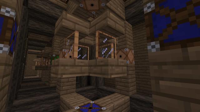 Strange wooden structure featuring blue laser emitters (turned off), glass panes, and laser detectors, all inset in a larger cubic wooden frame.